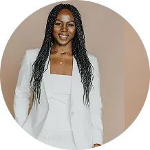 Smiling woman with braids in white suit