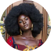Person with large afro and patterned dress