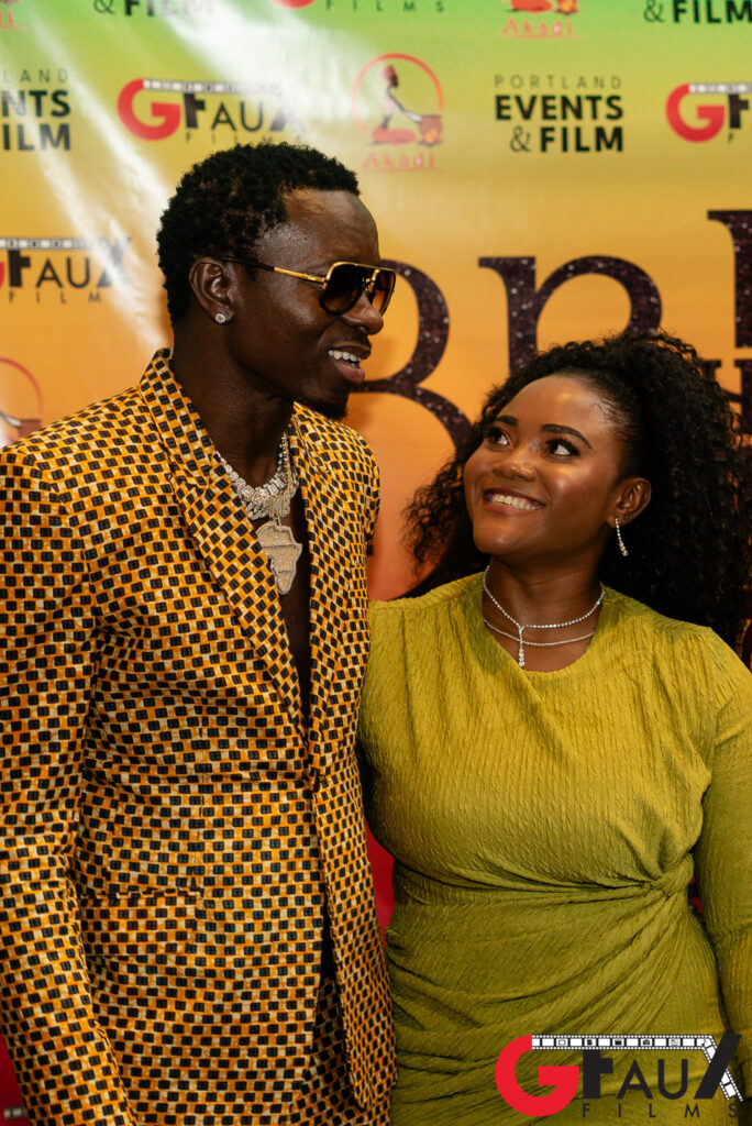Smiling couple in patterned suit and green dress