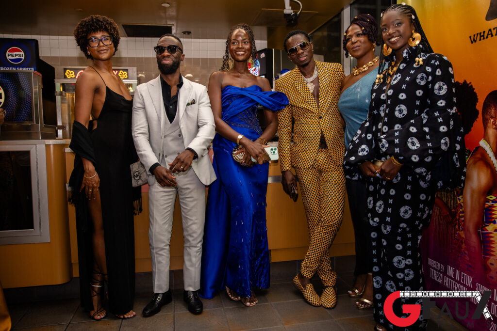 Six people in formal attire posing at event
