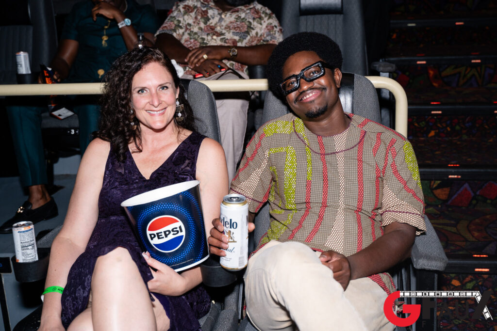 Smiling pair in theater with Pepsi bucket