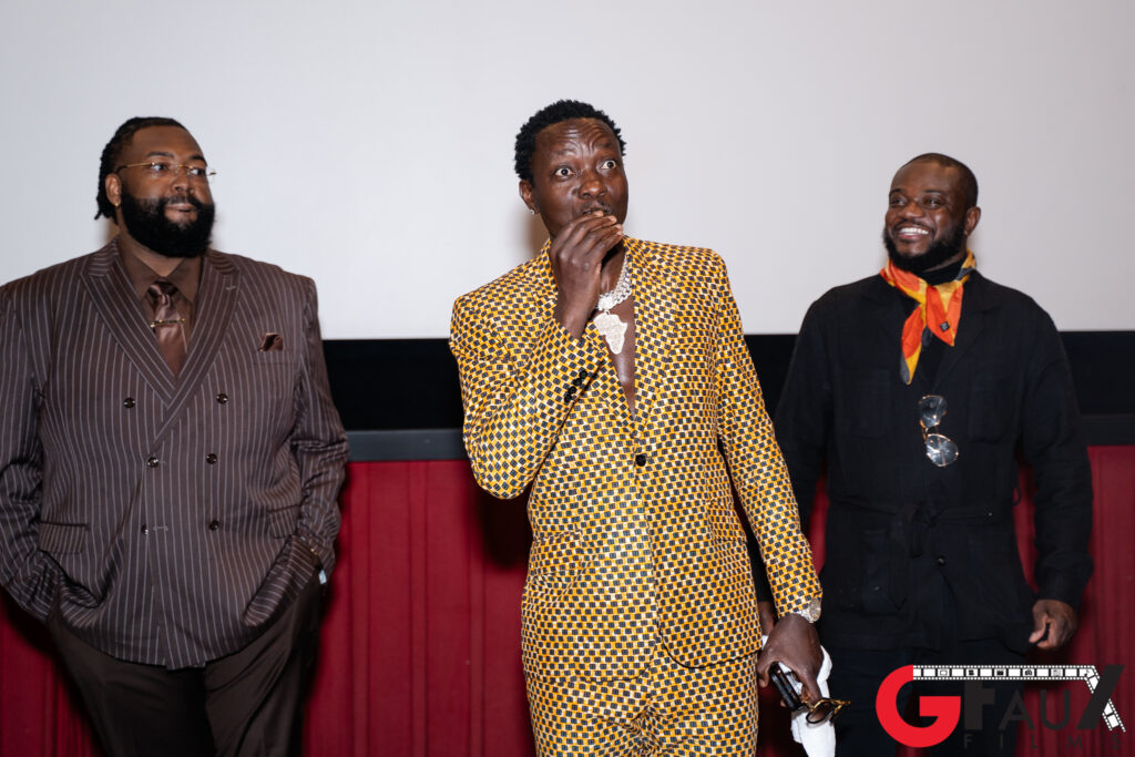 Three men in stylish suits on stage